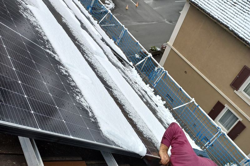 Solar installers working on a rooftop photovoltaic array